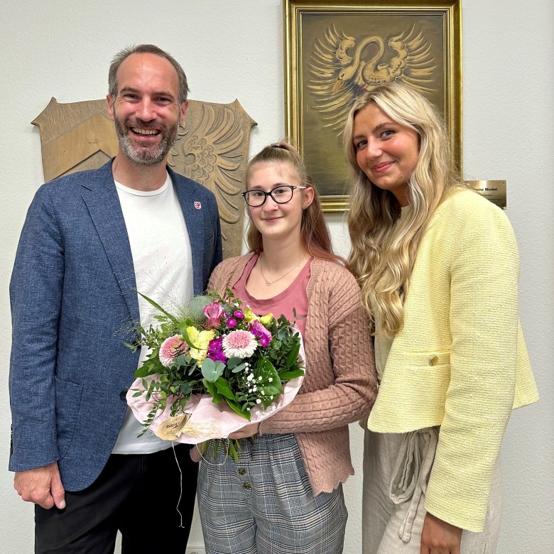 2 Frauen und 1 Mann stehend